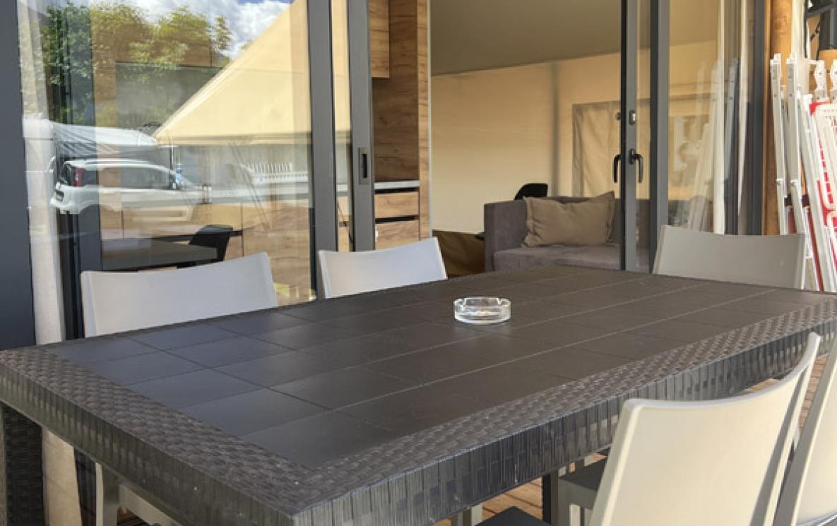 Outdoor table with chairs on a modern veranda.