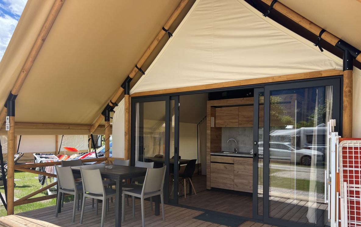 Glamping tent with terrace and outdoor kitchen.